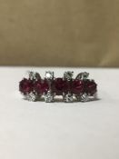 750 WHITE GOLD RING WITH EIGHT DIAMONDS SURROUNDING FIVE GARNETS, SIZE Q