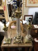 THREE BRASS AND GLASS COLUMN LAMPS, THE LARGEST 60CM