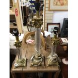 THREE BRASS AND GLASS COLUMN LAMPS, THE LARGEST 60CM