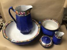 FIVE SIMILAR POTTERY BOWLS/VASES AND A JUG, ALL IN BLUE WITH FRUIT/VEGETABLE DESIGN ON RIMS, ONE