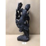 AN EBONISED CARVED WOODEN INDONESIAN FIGURINE, A/F, BEING 38CM IN HEIGHT