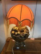 A LARGE VINTAGE LAMP WITH GILDED FRUIT BASE