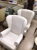 A PAIR OF CREAM UPHOLSTERED WINGBACK CHAIRS