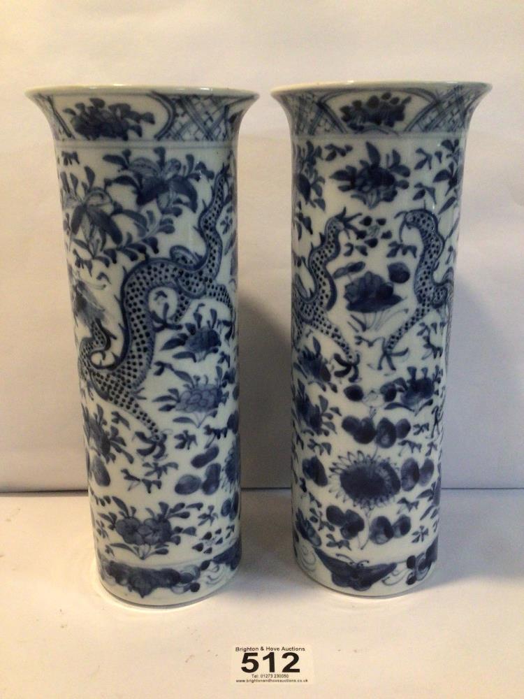 A PAIR OF CHINESE KANGXI BLUE AND WHITE SPILL VASES WITH SCROLLING DRAGONS AMIDST FLOWERING BLOOMS