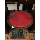 VINTAGE MAHOGANY ROUND TABLE WITH BRASS FRETWORK AND RED LEATHER TOP