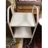 A VINTAGE METAL TWO TIER TROLLEY