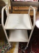 A VINTAGE METAL TWO TIER TROLLEY