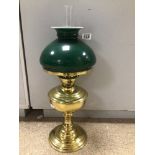 A VICTORIAN BRASS OIL LAMP WITH GREEN GLASS SHADE