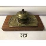 EARLY 20TH CENTURY BRASS INKWELL WITH LINER ON A WOODEN BASE