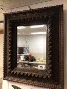 A WOODEN CARVED BEVELLED MIRROR, 37 X 44CM