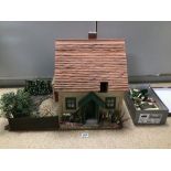 A VINTAGE DOLLS HOUSE WITH LIGHTING AND FURNITURE
