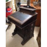 19TH CENTURY CARVED OAK DAVENPORT WITH LION HEADS