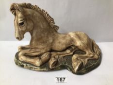 DAVID HENRY SIGNED CERAMIC FIGURE OF A HORSE LYING DOWN. 33CM X 21CM.