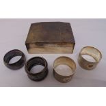 A silver cigarette box and four silver napkin rings, approx total weight 447g