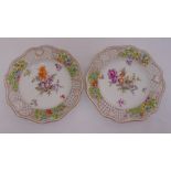A pair of late 19th century Meissen hand painted plates, with lattice pierced sides, decorated