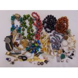 A quantity of costume jewellery to include wristwatches, beaded necklaces and a pair of lorgnettes