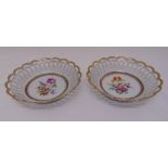 A pair of Dresden fruit bowls with pierced sides decorated with floral sprats to the centre, 22cm