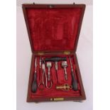 A Victorian mahogany cased set of surgical instruments, some with turned wooden handles, 20.5 x