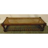 A rectangular oak foot stool with bergere top and barley twist stretchers, 23 x 91 x 33cm