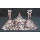 A continental rectangular glass dressing table tray with a matching pair of candlesticks and a