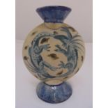 A ceramic flask decorated with dragons, on raised circular base, monogrammed NC to the side, 24cm (