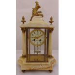 A French 19th century mantle clock, the brass mounted marble case supporting a circular enamel