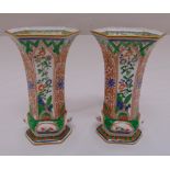 A pair of Chinese style hexagonal vases decorated with flowers and leaves on raised hexagonal bases,