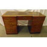 Mahogany rectangular kneehole desk with tooled leather top, nine drawers with brass swing handles,