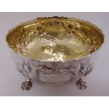 A Victorian silver bowl, the sides chased with flowers and leaves, crimped edge, gilt interior on