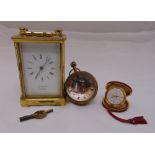 A Victorian brass carriage clock of customary form to include key, a glass globular desk watch and a
