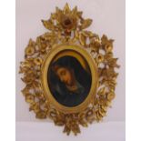 A framed oil on panel of a lady in 18th century style, the frame pierced and carved with flowers and