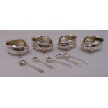 A set of four Victorian silver salts with crimped edges on four scroll feet, London 1899 and five