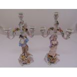 A pair of Sitzendorf figural three branch candelabra on naturalistic bases, 44cm (h)