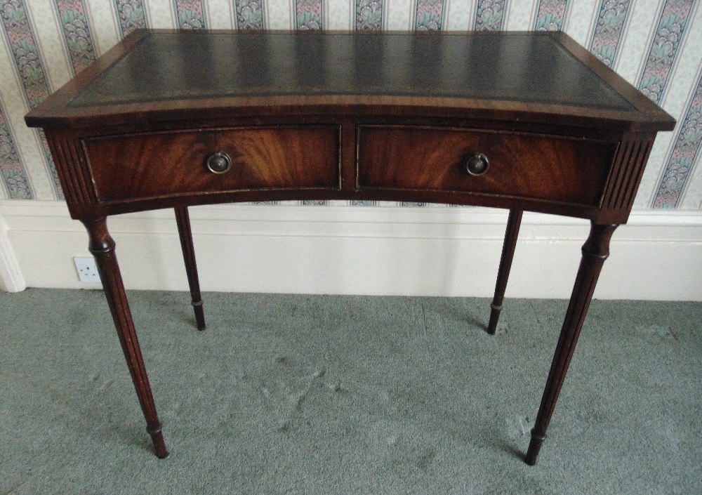 A rectangular mahogany desk with two drawers, tooled leather top on tapering cylindrical legs, 78