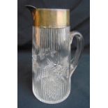 A cut glass lemonade jug of ribbed cylindrical form with plain hallmarked silver collar and spout