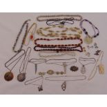 A quantity of costume jewellery to include necklaces and brooches