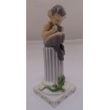 Royal Copenhagen figurine of a faun seated on column with a lizard on the square base, marks to