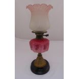 A Victorian brass oil lamp with octagonal ceramic reservoir, glass shade on turned wooden base, 49cm