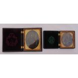 Two framed Victorian daguerreotypes of a gentleman and lady in carved ebony frames, 10 x 12.5 cm and