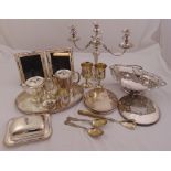 A quantity of silver plate to include a tray, a fruit basket, a photograph frame, a candelabrum, a