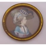 A 19th century miniature of a lady in a hat, 7.5cm diameter
