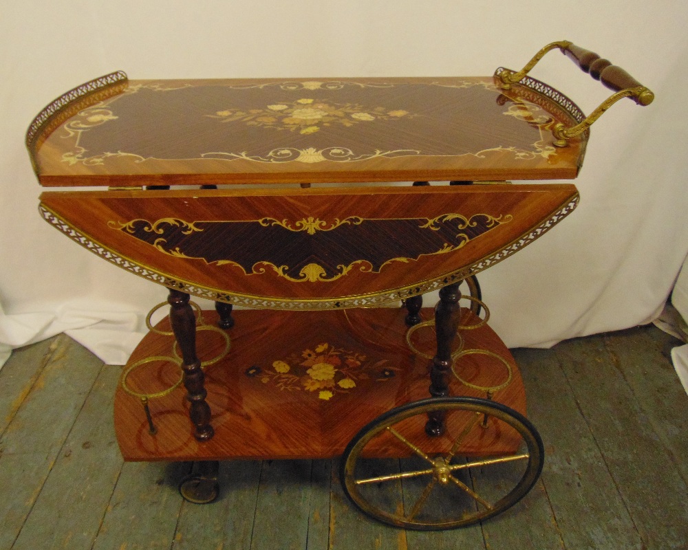 An Italian Sorrento style drinks trolley inlaid with floral and leaf clusters, two drop flaps,
