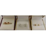 Three pairs of 9ct gold earrings set with various coloured stones