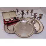 A quantity of silver plate to include trays, a pair of candelabra and cased condiments