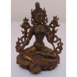 A Tibetan gilded bronze figurine of Buddha on shaped oval base, 20cm (h)