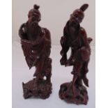 A pair of oriental carved hard wood figurines of elders on raised naturalistic bases, 30cm (h)