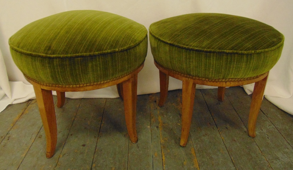 A pair of circular upholstered stools on four outswept legs, 44.5 x 50cm