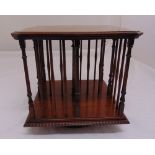 An Edwardian mahogany revolving table top bookcase, shaped square with turned columns, 34cm (h)