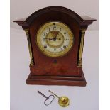 An Edwardian bracket clock of architectural form, silvered dial, Roman numerals, two train movement,