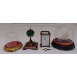 A brass carriage clock and key, a pocket watch stand on raised square base and two Victorian glass